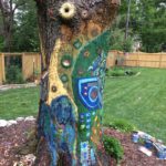 paintings on a storm-damaged tree