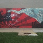 A mural with a statue of liberty and a flag on it.