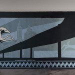 A black and white painting of a ship on a wall.