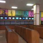 Empty betting counters with colorful wall art.