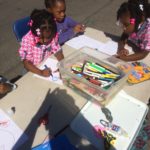 A group of children sitting at a table.