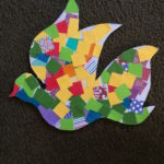 A colorful dove made out of pieces of paper.