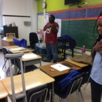 A girl standing in a classroom.