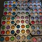 Tins filled with different colored scrapbook paper.