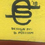 A yellow wall with a design by d pulliam.