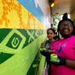 girls painting a mural