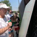 A group of people looking at a white board.