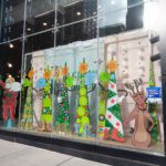 Holiday-themed window display with cartoon characters.