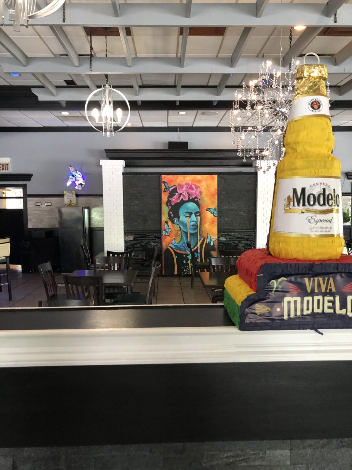 Restaurant interior with Modelo beer display.
