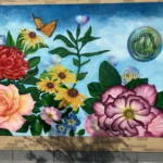 A colorful mural with large flowers and a butterfly against a blue sky.